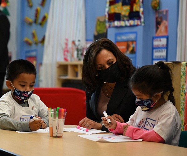 kamala harris sits with 2 kids who are coloring