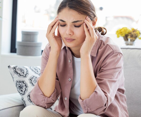a woman suffering from a headache