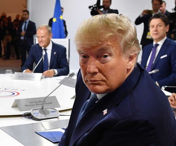 president donald trump smiles from the leaders' table at the g-7
