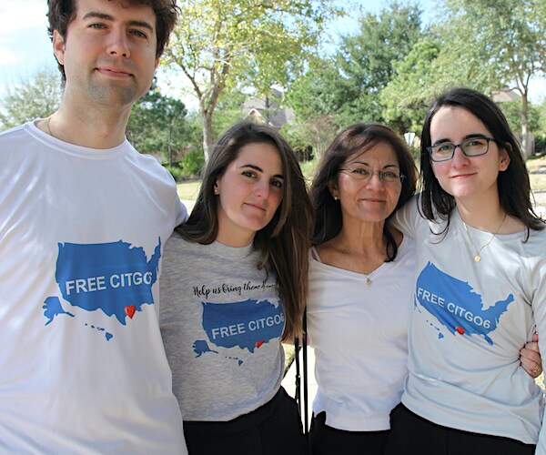 Wearing T-shirts with the message "Free the Citgo 6," the Tomeu Vadell family poses for a photo in Katy, Texas