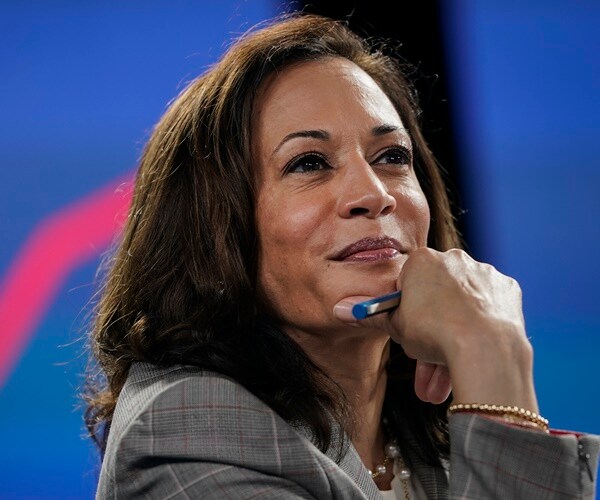 sen. kamala harris listens to a briefing