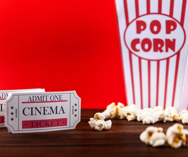 Bucket Of Popcorn With Two Red Movie Tickets
