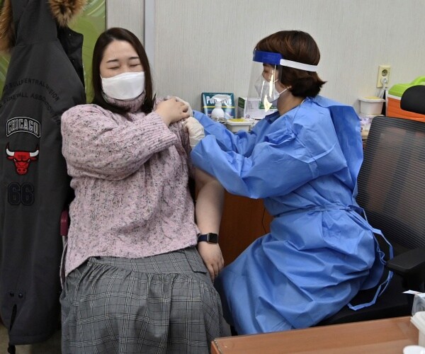 A woman receiving a COVID vaccine