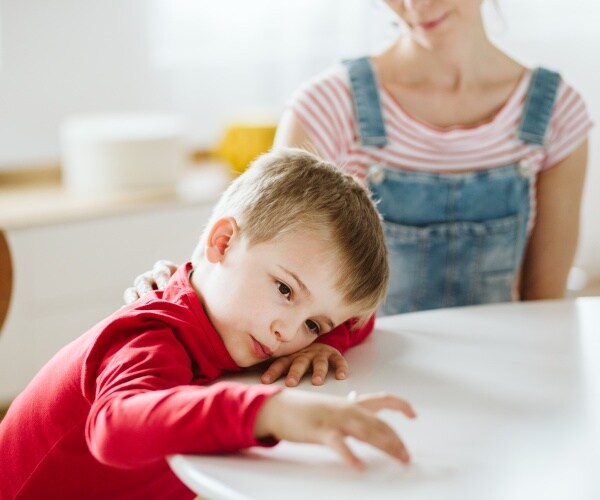 mom trying to talk to child with ADHD who is not listening