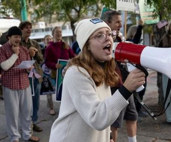 woman speaks into a bullhorn