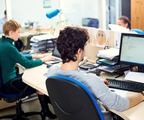office with two people working on computers