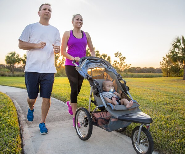 a family running with a jogging stroller
