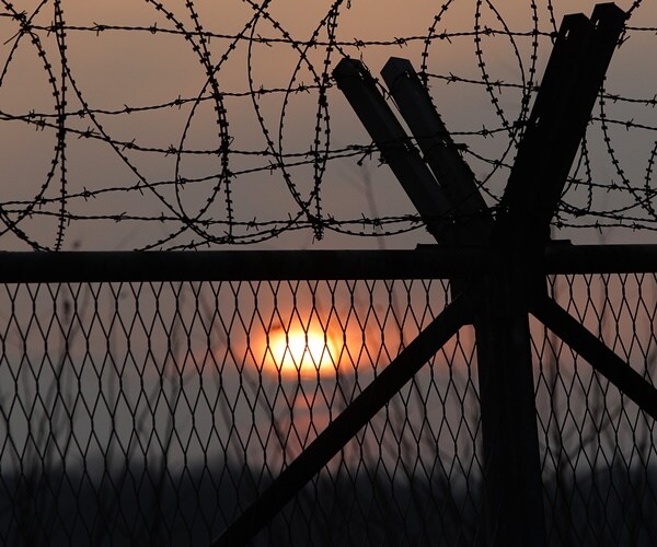 razoer wire tops a fence between south and north korea where a nuclear test was last conducted