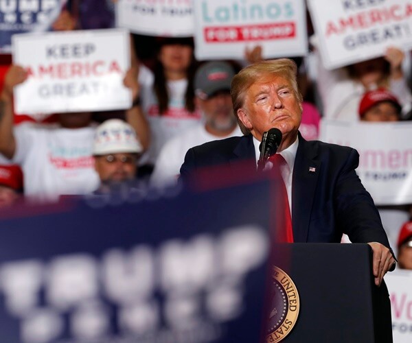 president trump stands at a podium during a rally in new mexico