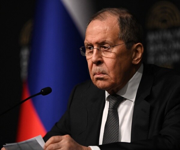Sergei Lavrov looks on as he meets Ukraine's Foreign Minister