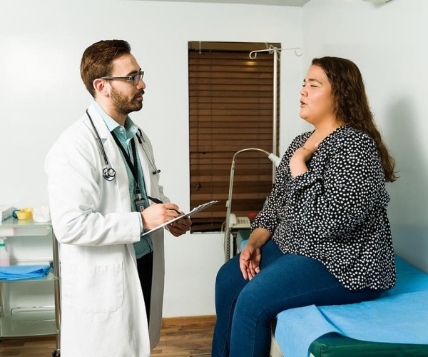 overweight woman talking to doctor in office