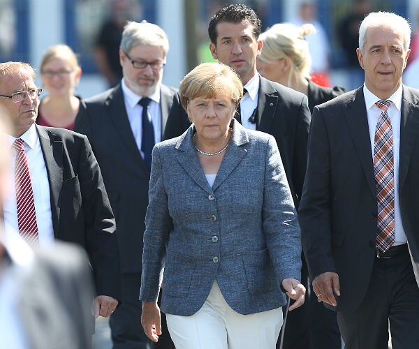 Merkel, Heckled on Visit to Refugees, Says No to Xenophobia