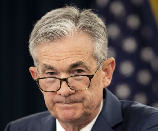 fed chair jay powell is show with his glasses tipping of his nose