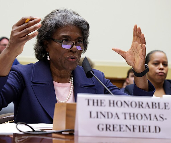 Linda Thomas-Greenfield sitting at a table, gesturing with both hands