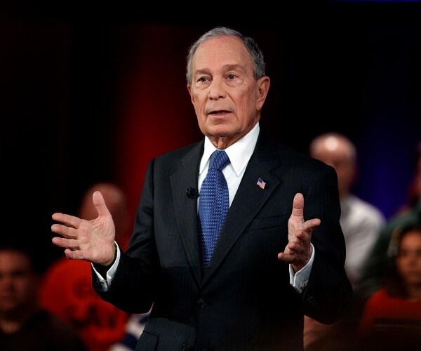 mike bloomberg stands on stage