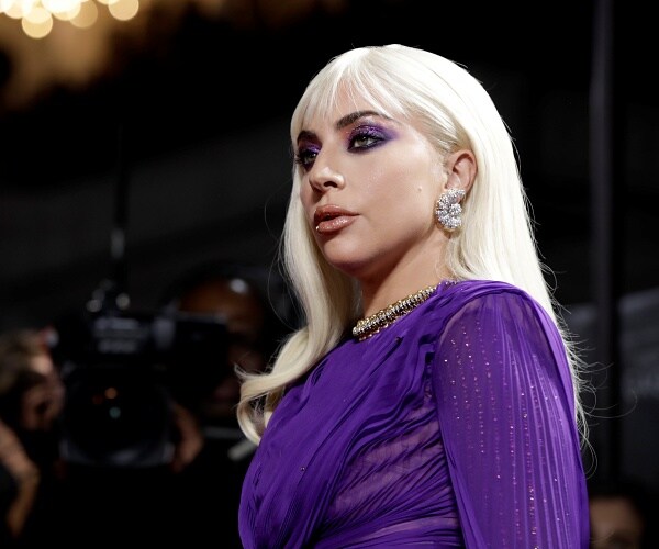 lady gaga stands on red carpet