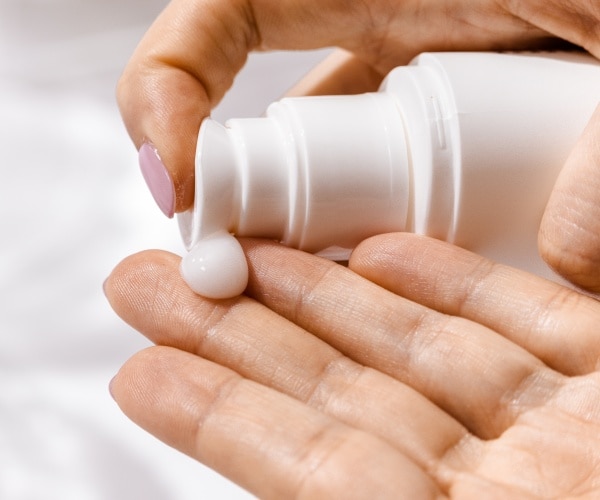 closeup of putting cream in hand