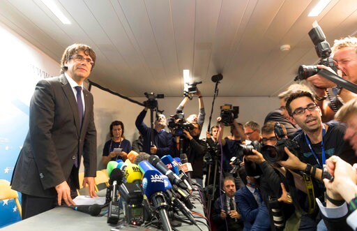 The Latest: Lawyer Says Puigdemont Won't Go Back for Weeks