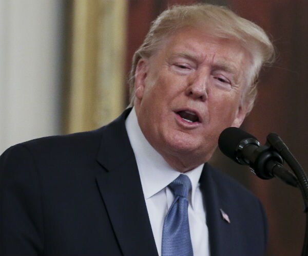 president donald trump is shown in blue suit, tie and dress shirt