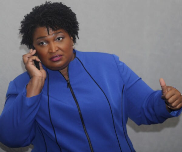 georgia gubernatorial candidate stacey abrams answers her phone before speaking in detroit