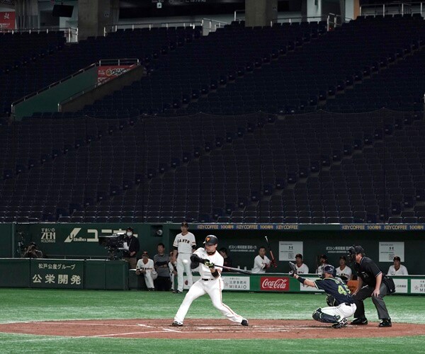 a player swings a bat in an empty stadium