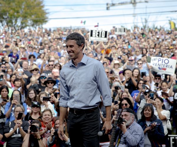 beto o'rourke smiles as he takes the stage to speak in austin. 