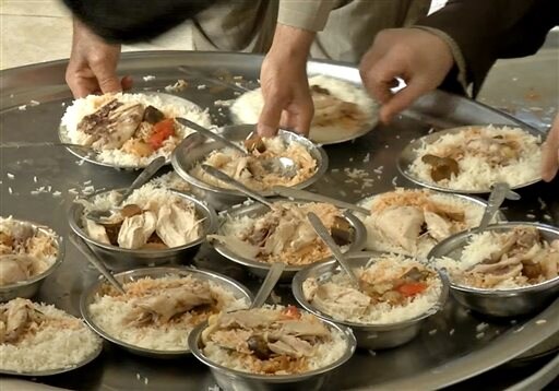 Displaced Iraqis Find Warm Meals at Sufi Shrine