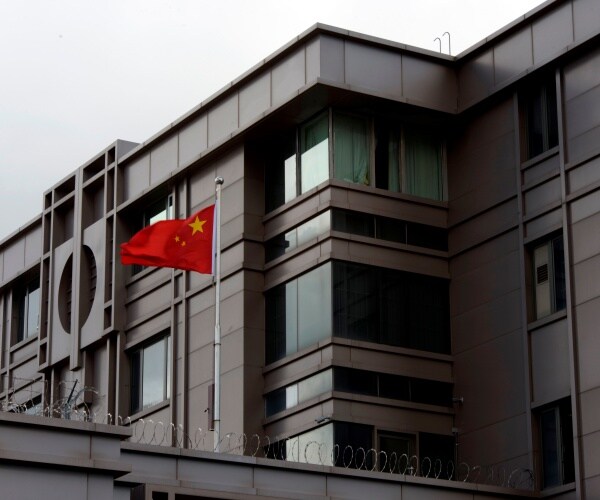 chinese flag flies outside the building of the houston consulate