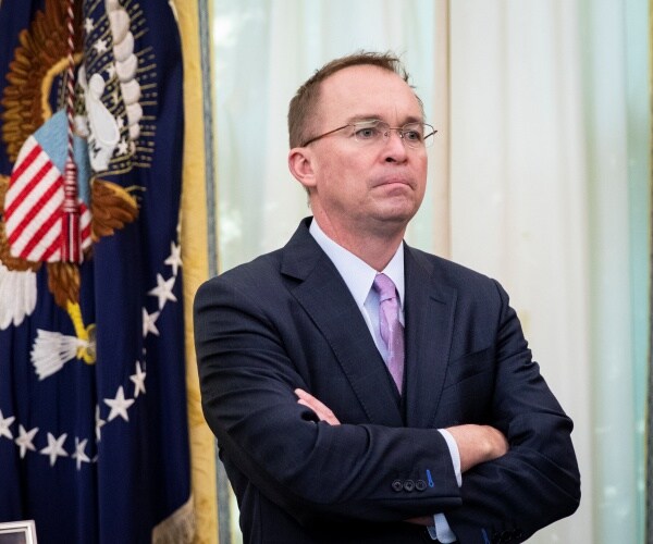 mick mulvaney stands in oval office