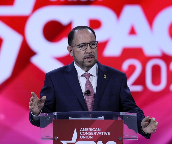 robert unanue speaks into mic