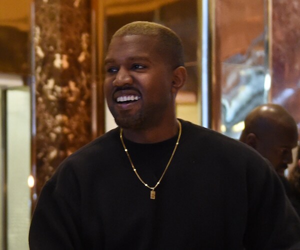 rapper kanye west is shown wearing a black sweater 