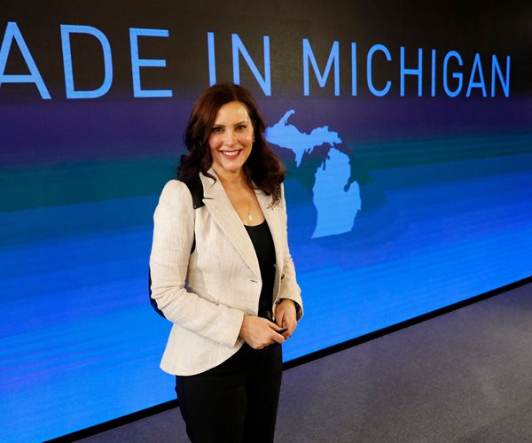 Gretchen Whitmer standing in front of Made in Michigan sign
