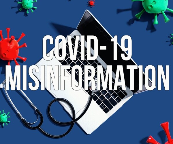 laptop computer screen says "COVID Misinformation" with coronavirus particles around it