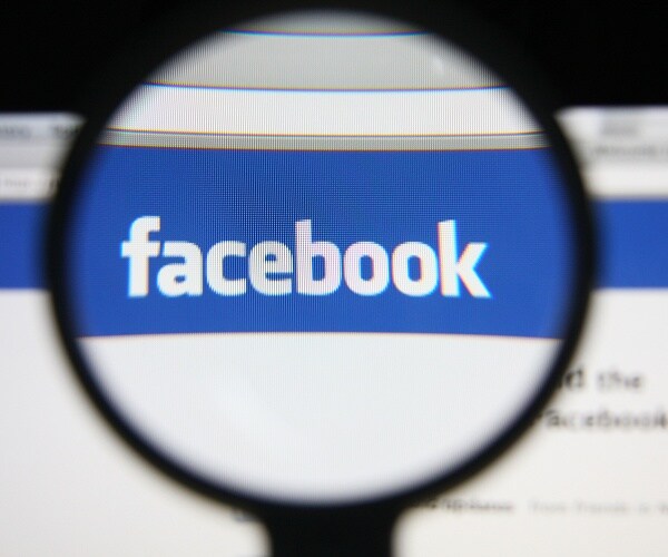 facebook logo under magnifying glass