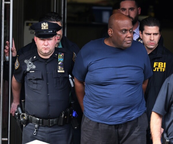 frank james is led by police after being arrested