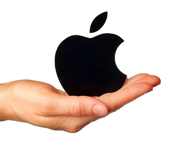 hand holds apple logotype printed on paper on white background.Apple 