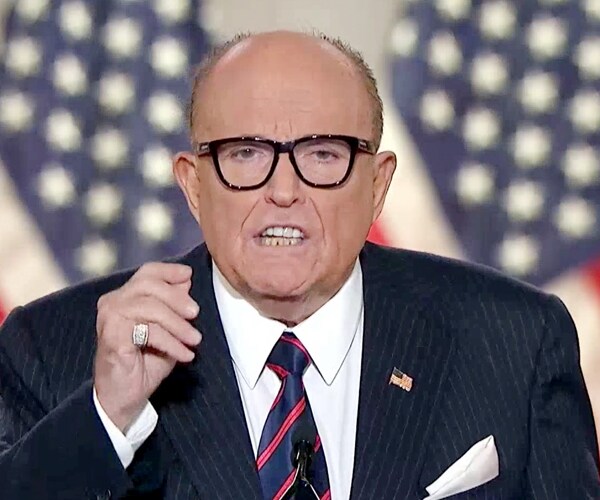 rudy giuliani speaks at a microphone during the republican national convention