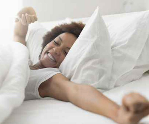 photo shows a smiling woman waking up