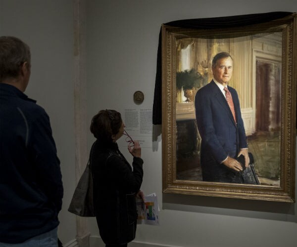 george h.w. bush's portrait is draped in black cloth at the national portrait gallery in washington, to mark his passing