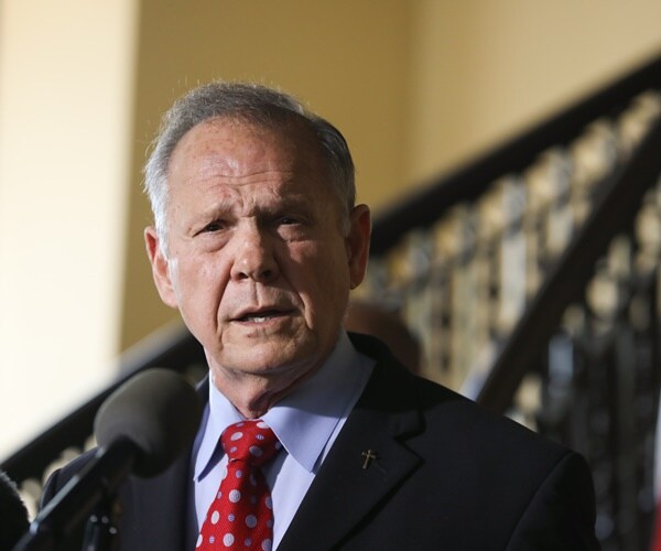 roy moore speaks into a mic