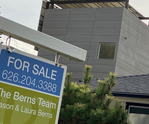 for sale sign in front of home