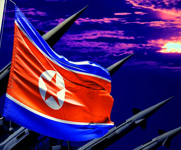 a north korean flag is shown in front of missiles pointed to a dusk sky in an illustration