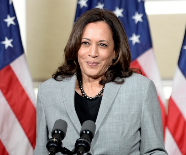 kamala harris stands at podium