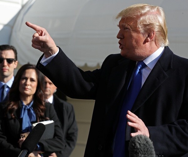 donald trump talks to press as stephanie grisham listens