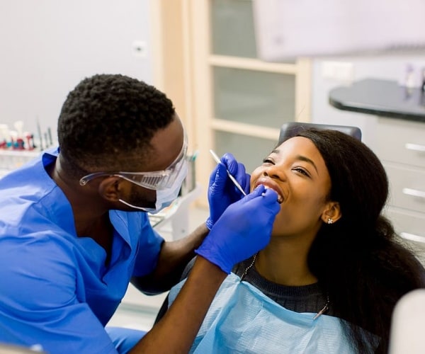 dentist looking in patient's mouth