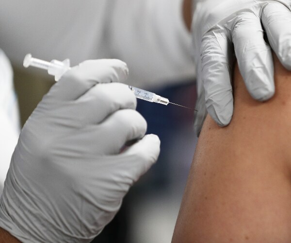 a vaccine is being given in an arm
