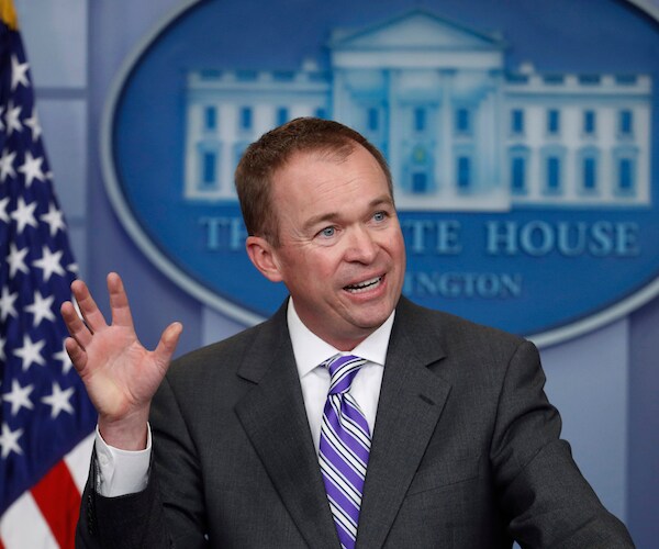mick mulvaney gestures with his right hand while speaking in the white house press room during a news conference