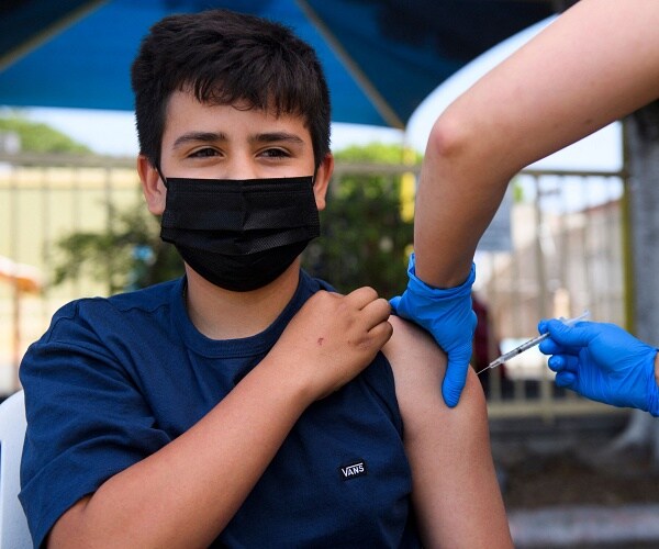 boy receives coronavirus vaccine shot