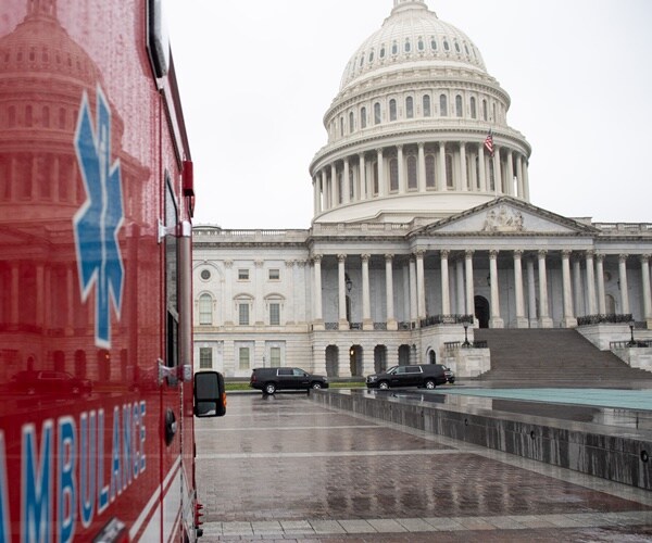 the capitol is reflected in an ambulance