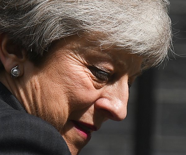 theresa may faces to the right in tightly cropped profile 